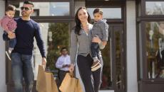 A family with small children walks with shopping bags in the Georgetown neighbourhood of Washington, DC.